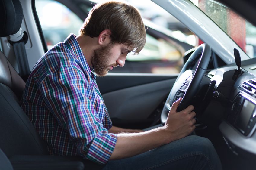 man in car upset because he has been charged